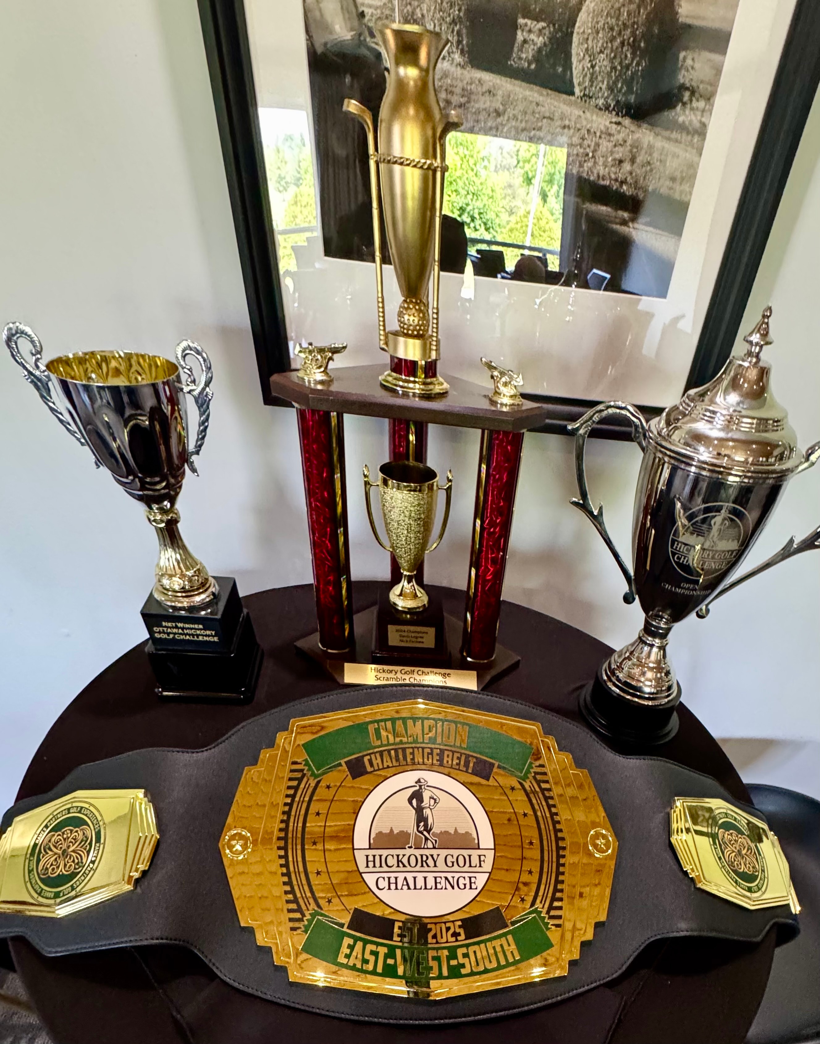 Full display of Ottawa Hickory Golf Challenge trophies and champion belt
